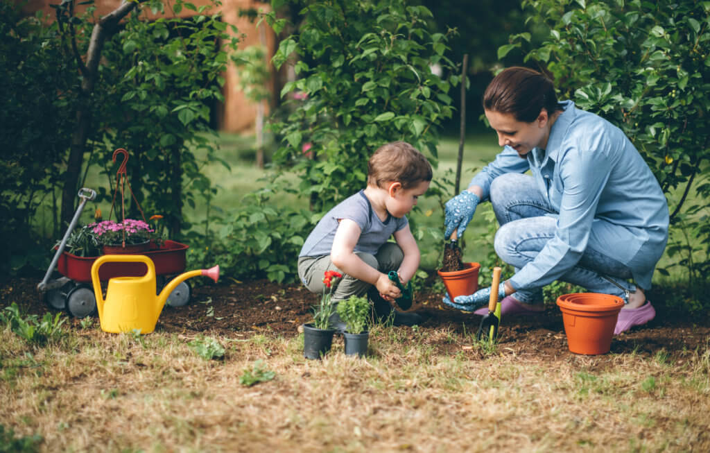 mother and son planting garden to be eco-friendly